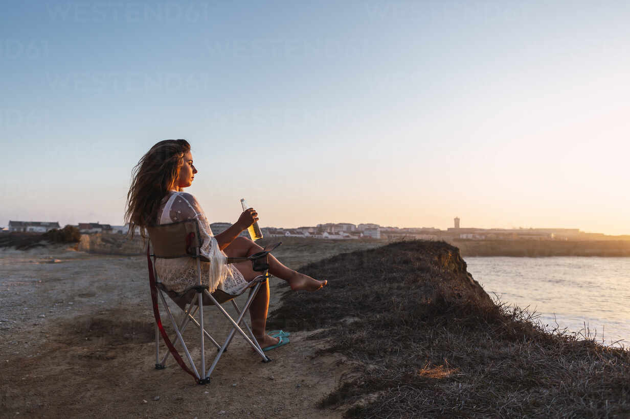 files/woman-drinking-white-wine-while-sitting-on-chair-at-beach-during-sunset-DCRF00991.jpg